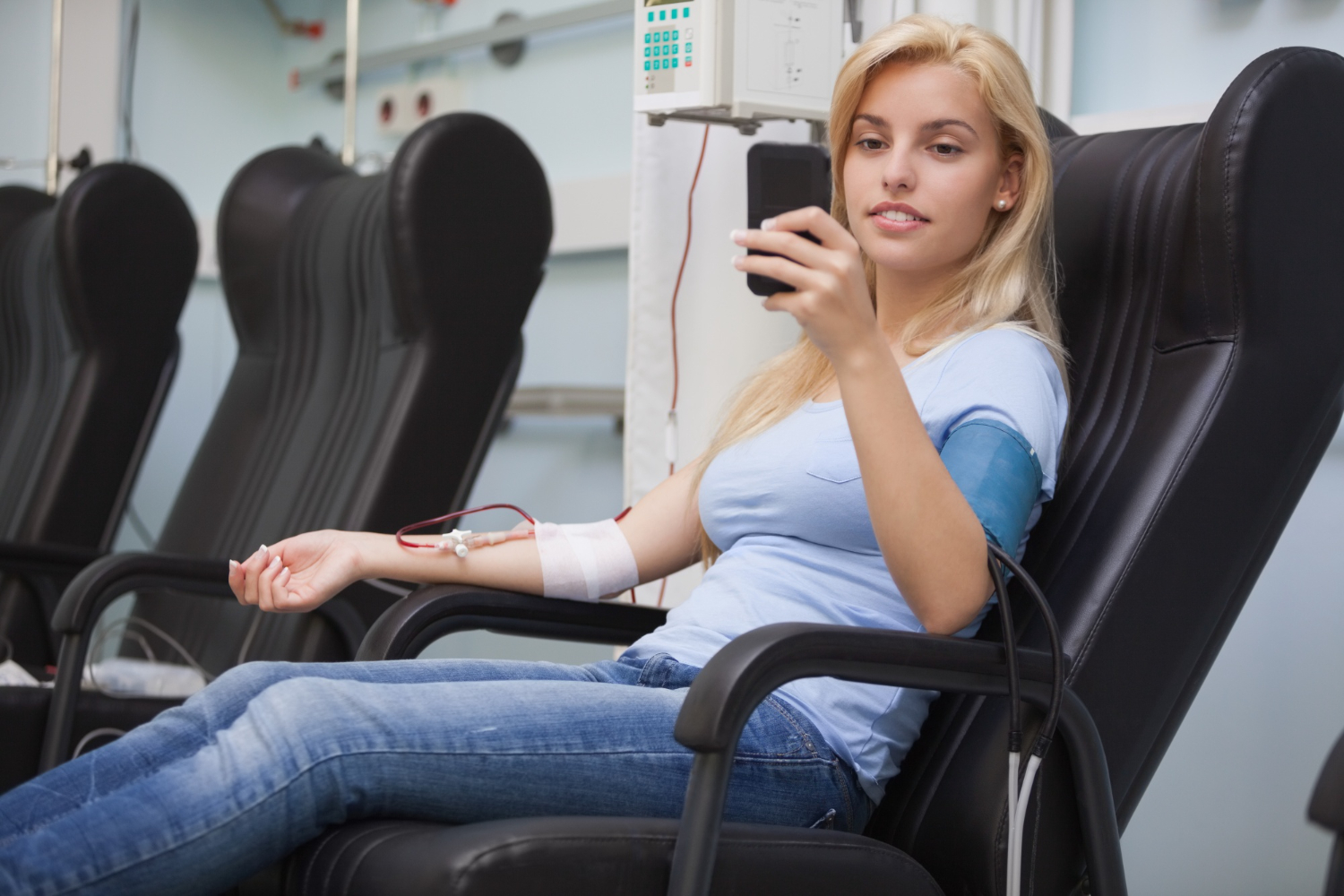 blonde-woman-relaxing-chair-while-getting-dialysis