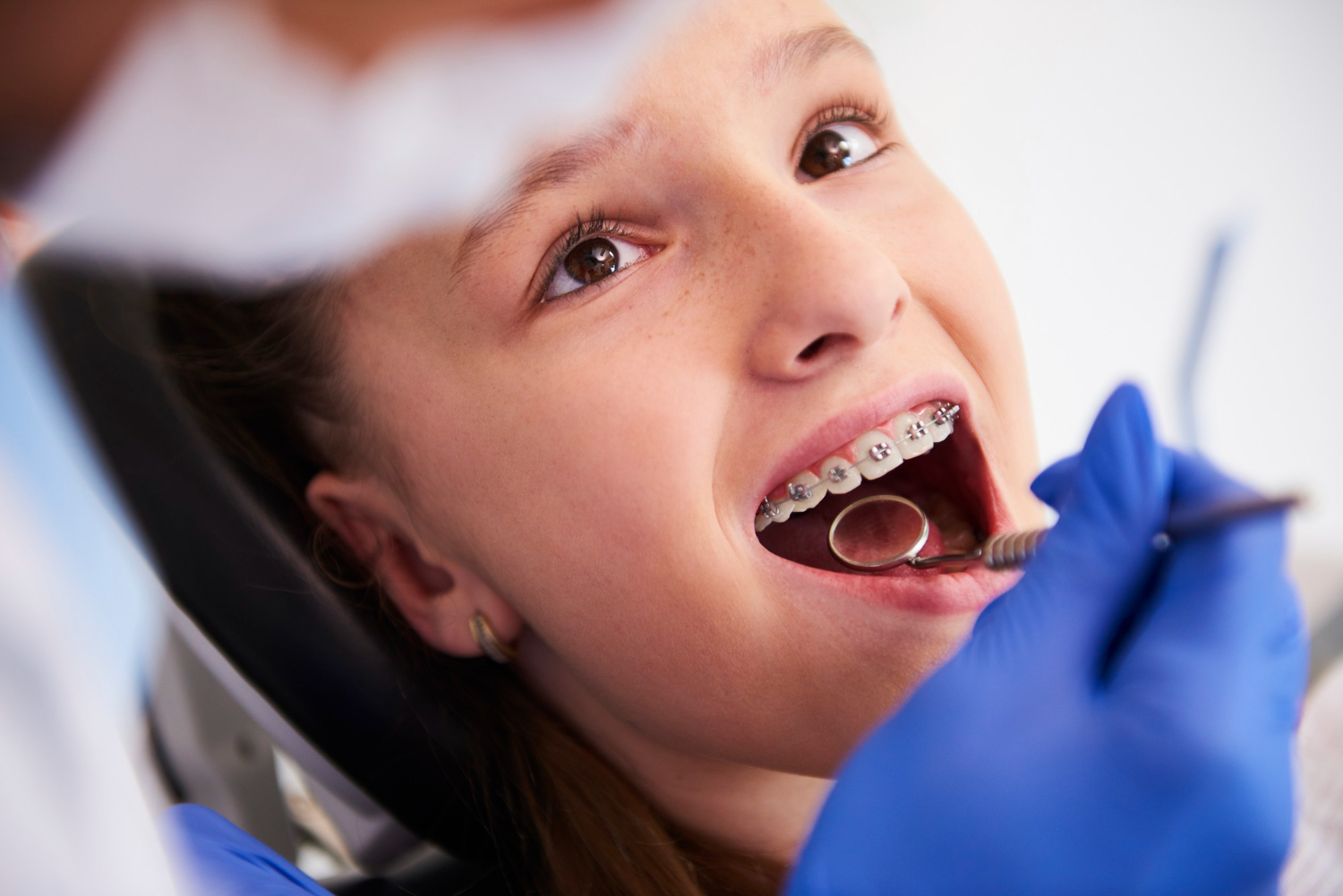 girl-with-braces-during-routine-dental-examination